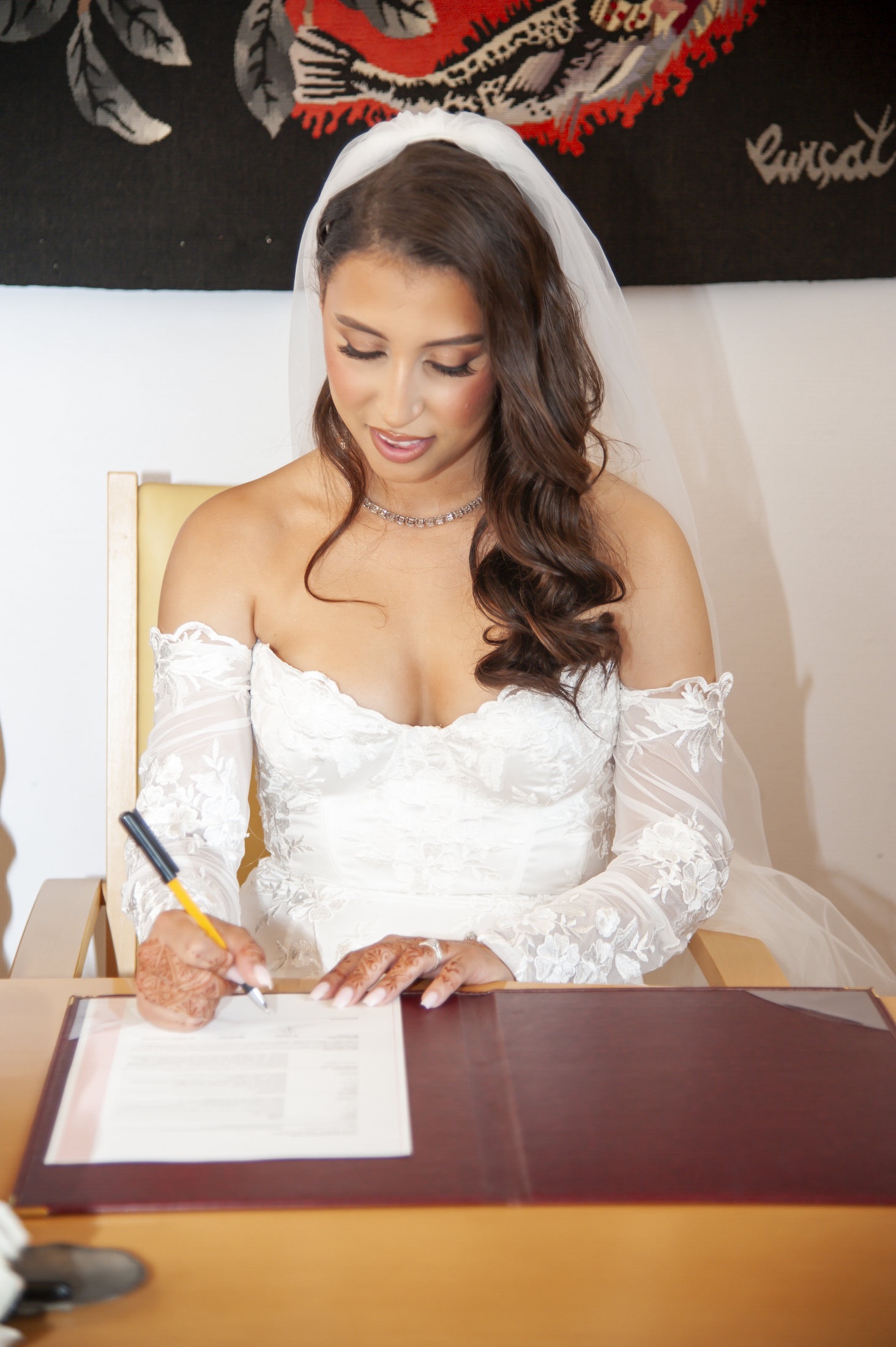 La mariée signe le registre avant la cérémonie